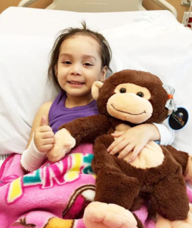 Cancer Child with Warmkins Toys